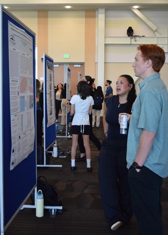 Student presenting their showcase board