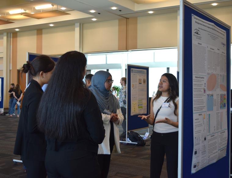 Student presenting their showcase board