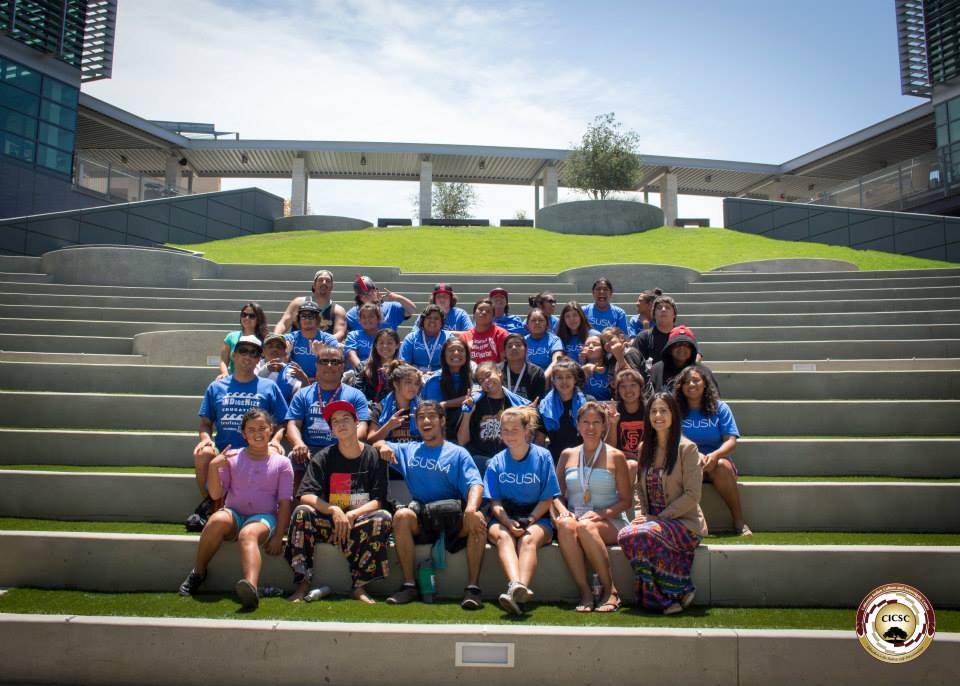 Group of participants from the InterTribal Youth Summer Educational Tour sitting together on outdoor steps at CSUSM