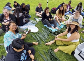 Participants sitting together on a lawn