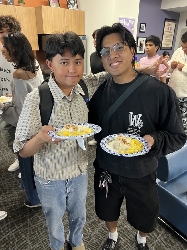 Two students eating at an event