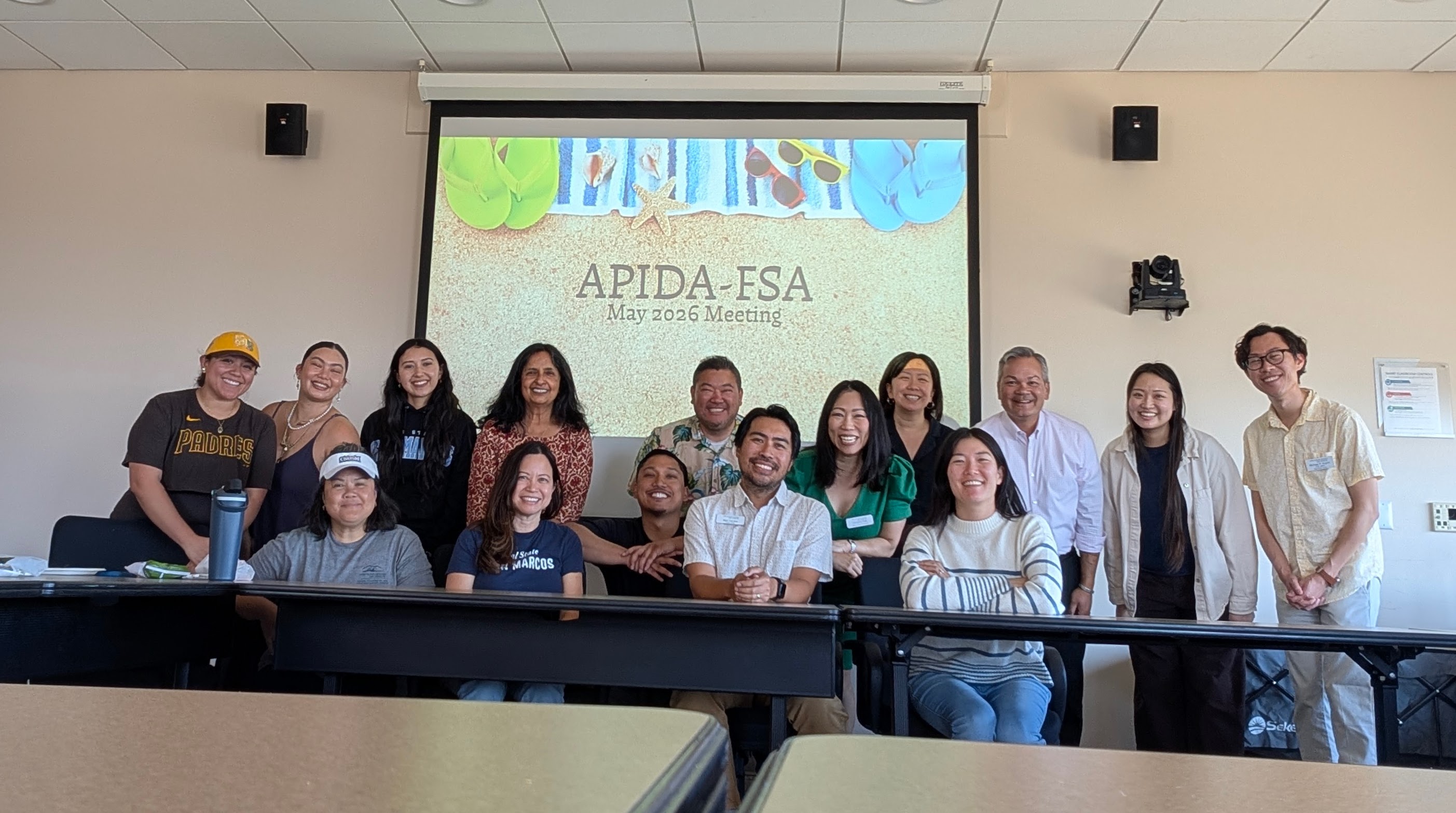 group of association members sit in front of projector screen reading apida fsa meeting