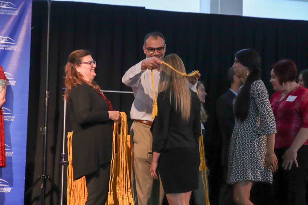 Students receiving dean's list chord during graduation