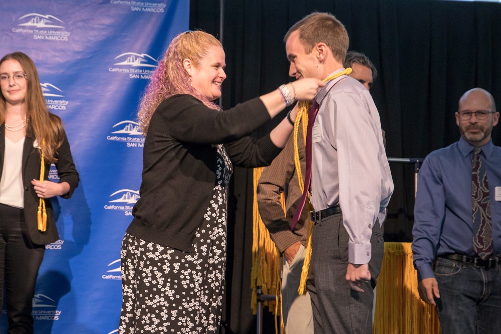Student is corded for earning Latin Honors