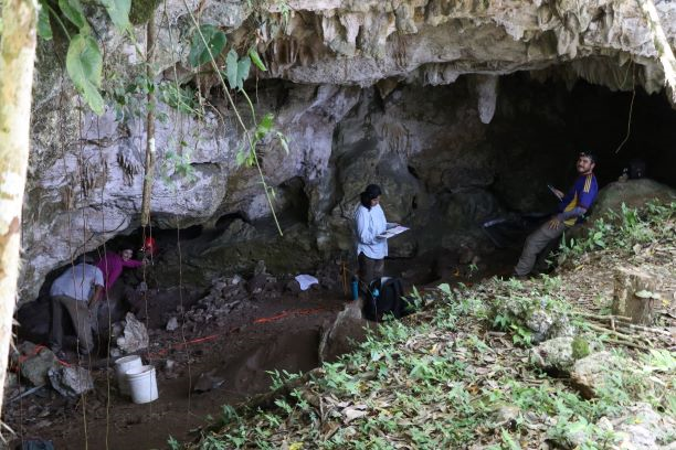 Archaeology students working in a cave in Belize.
