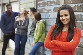 Teenagers gathered next to a building