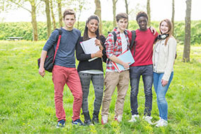 A group of teenagers gathered outdoors