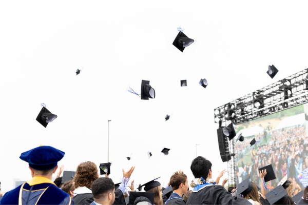 Graduate Caps thrown in the air during Spring Commencement at the CSUSM Mangrum Track CSUSM Commencement Office
