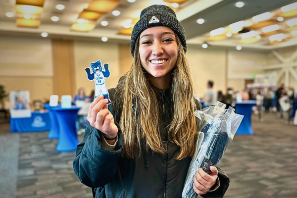 student holding up merchandise