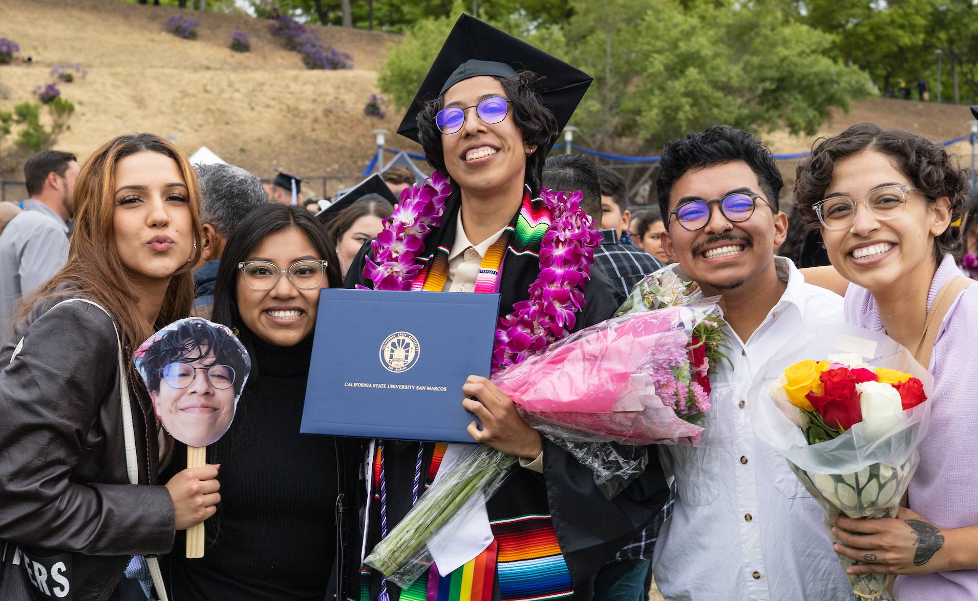 Family lifting their graduate
