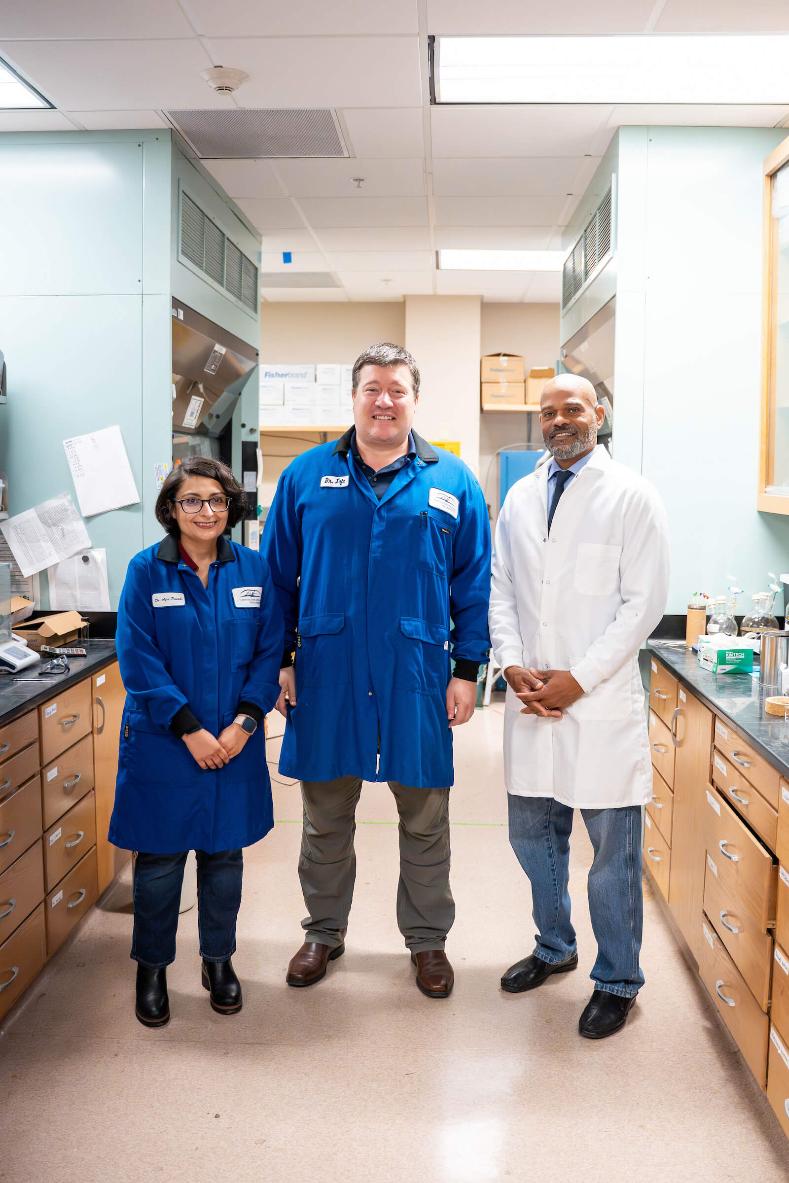 three faculty members in a lab
