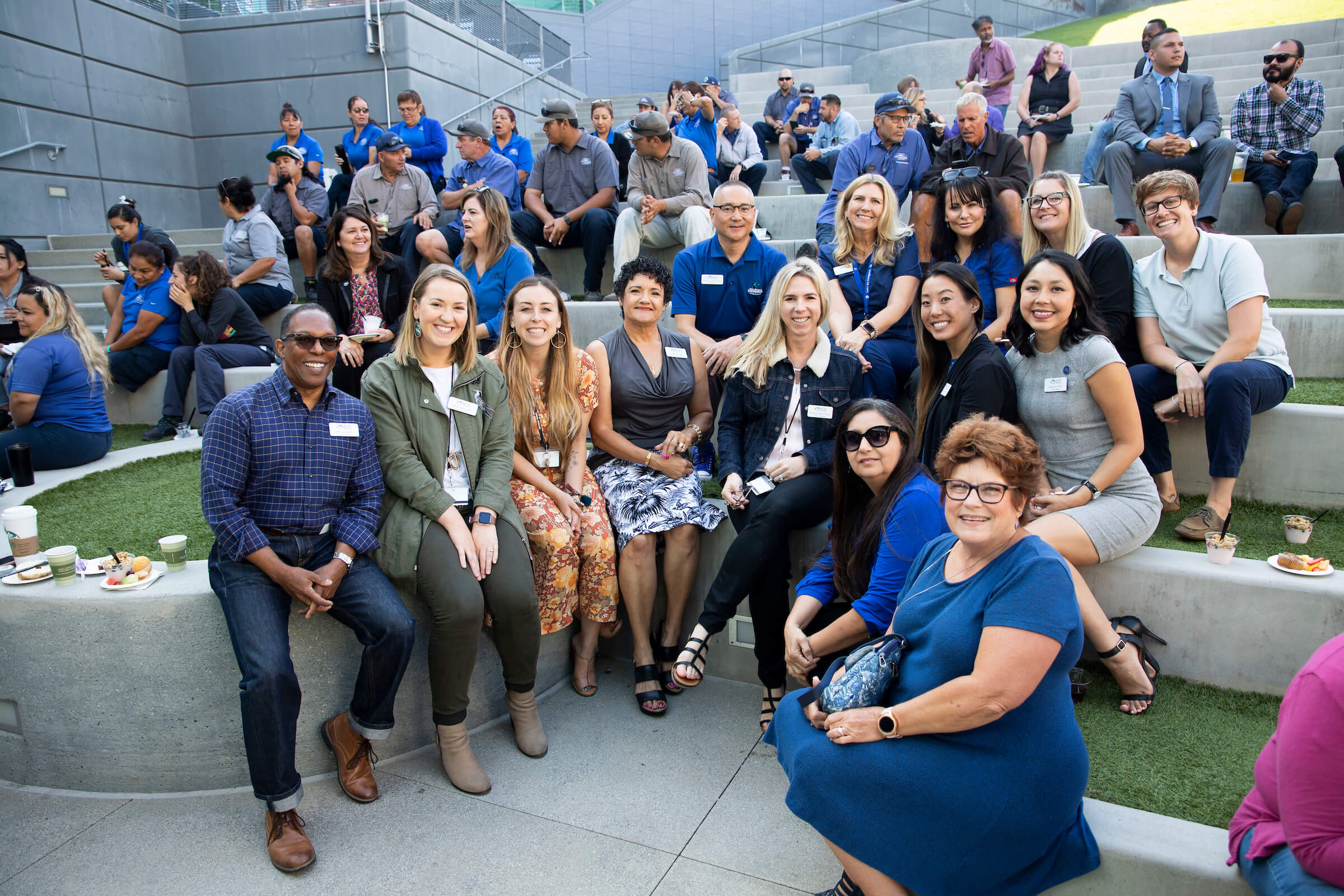 group of faculty and staff members sitting at the USU lawn