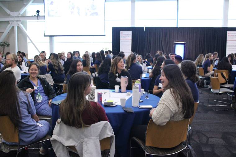 participants at tables for the IPE training and programming