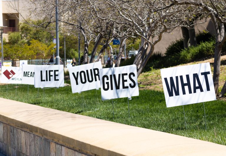 Signs in grass 'What gives your life meaning?'