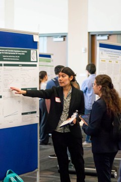 research woman giving poster presentation