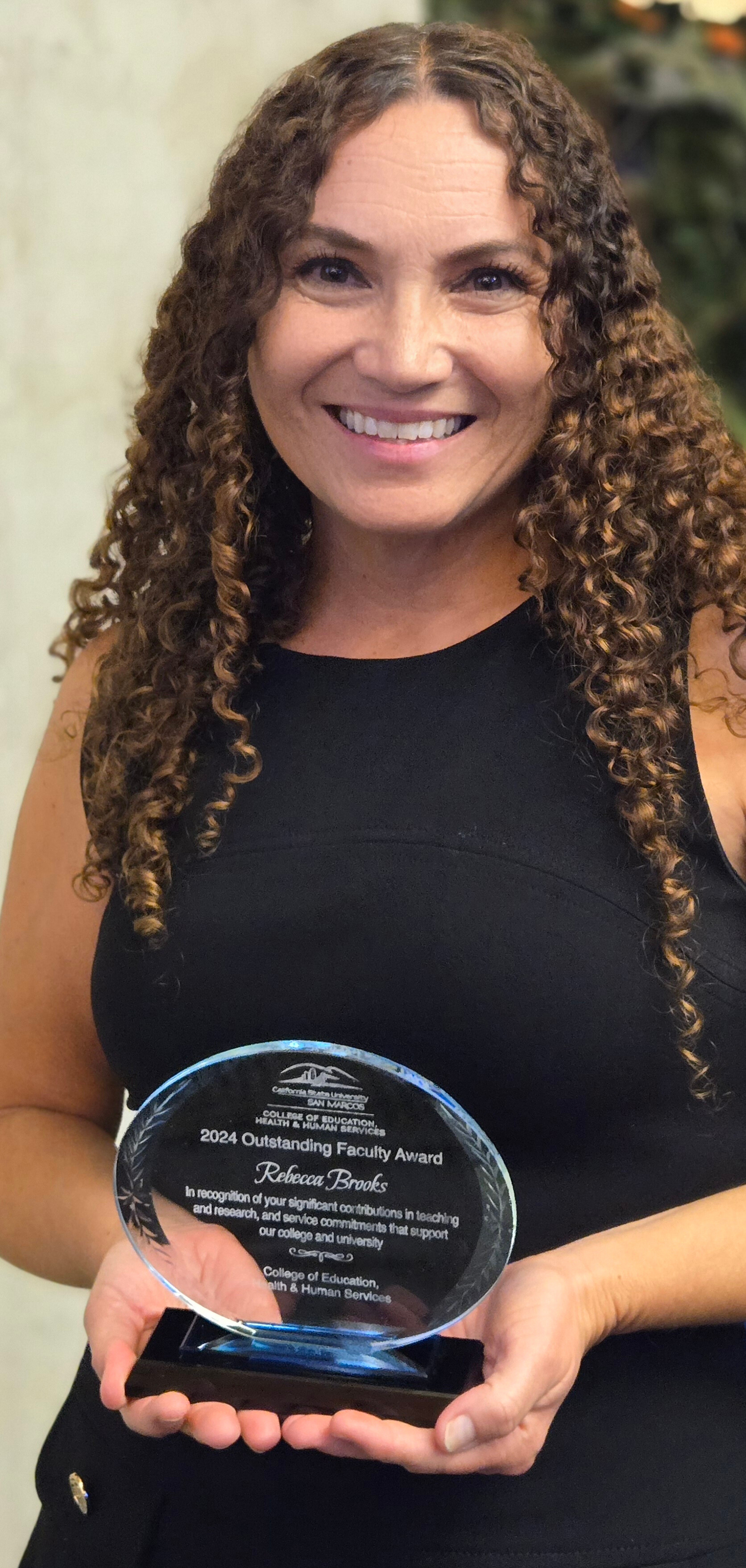 Dr. Brooks holding award Dr. Brooks holding award