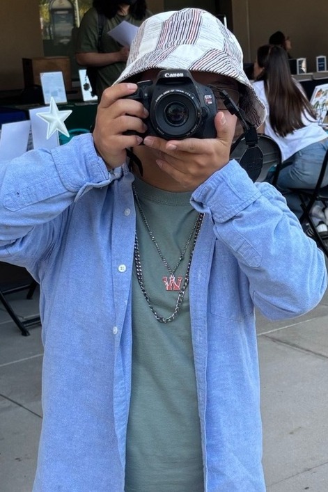 Student, William Yang, taking photos at a campus event
