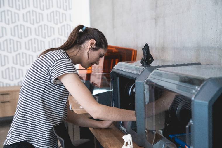 Woman setting up the 3d printer
