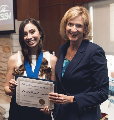Krystal Alvarez-Hernandez receiving the 2022 CSUSM President's Outstanding Graduate