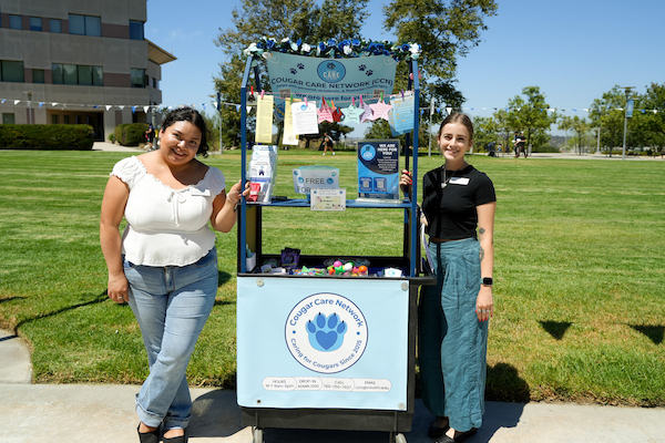 two people standing next to a cart