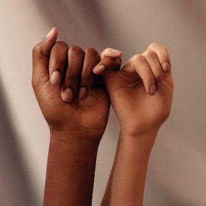 Photo of two hands held around each other's pinkies.