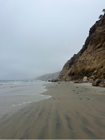 coastline beach with cliffs and clouds