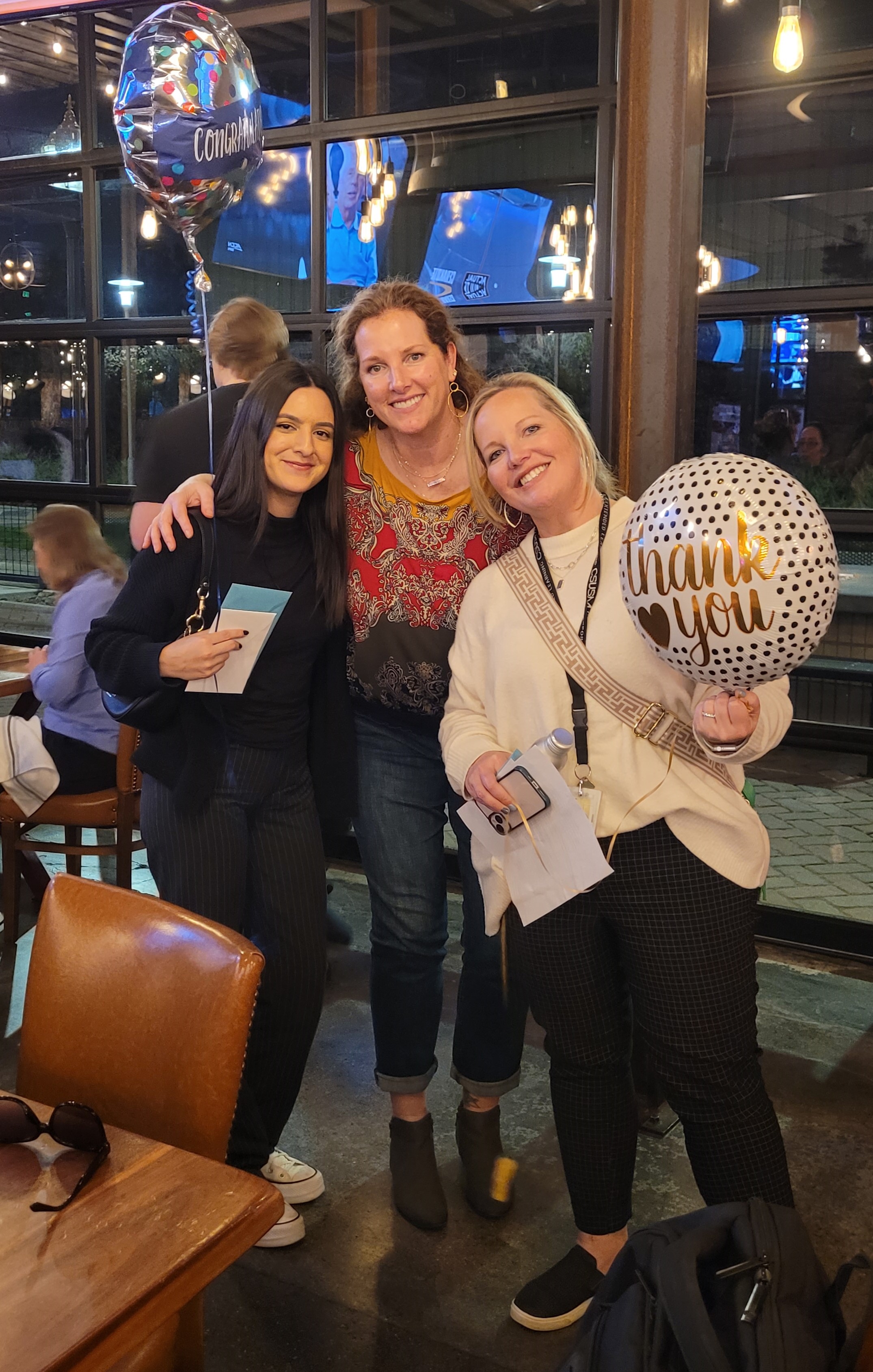 Three people with balloons