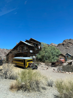 Deserted ghost town with run town wood house and school bus.