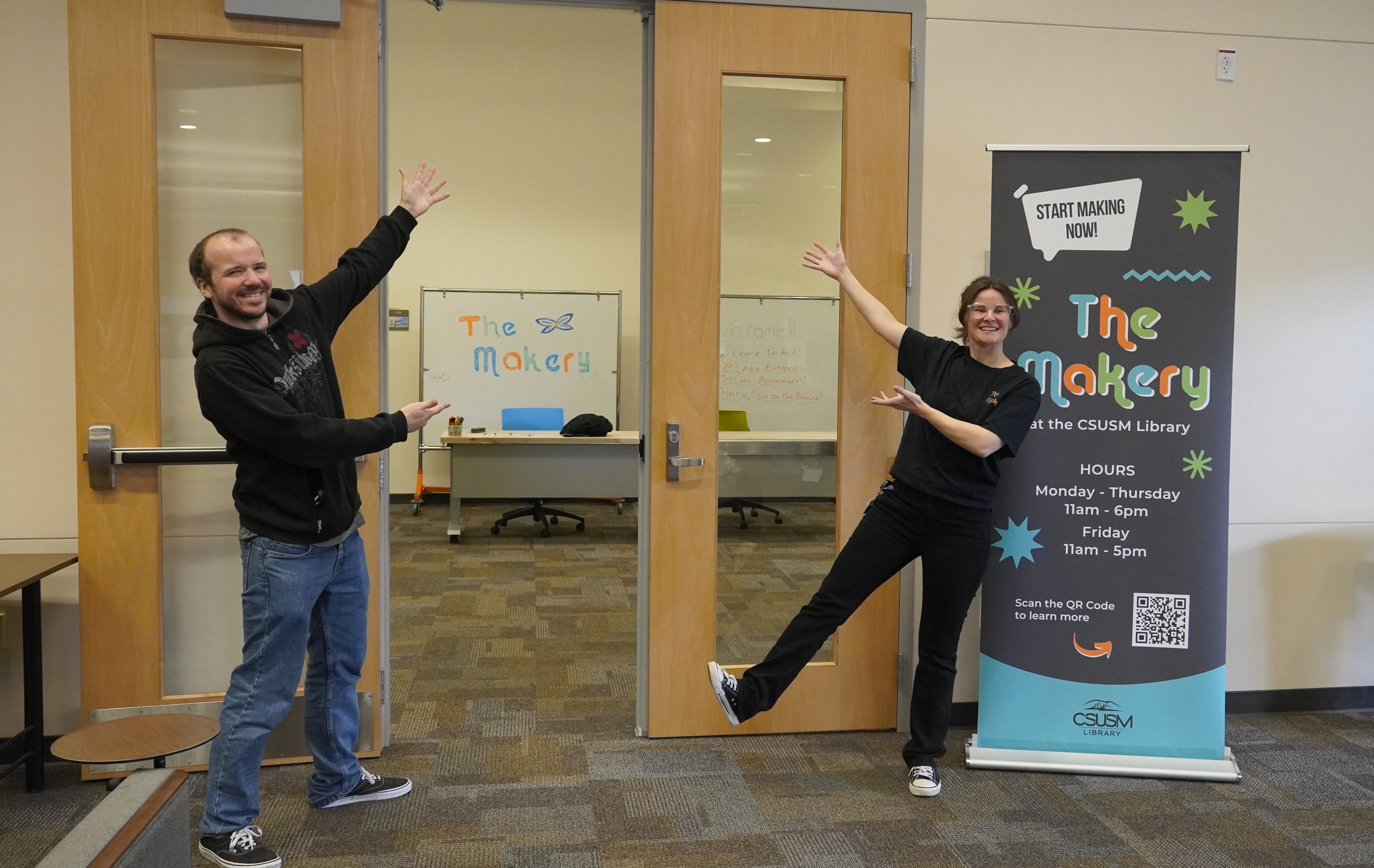 Two people pointing to a door.