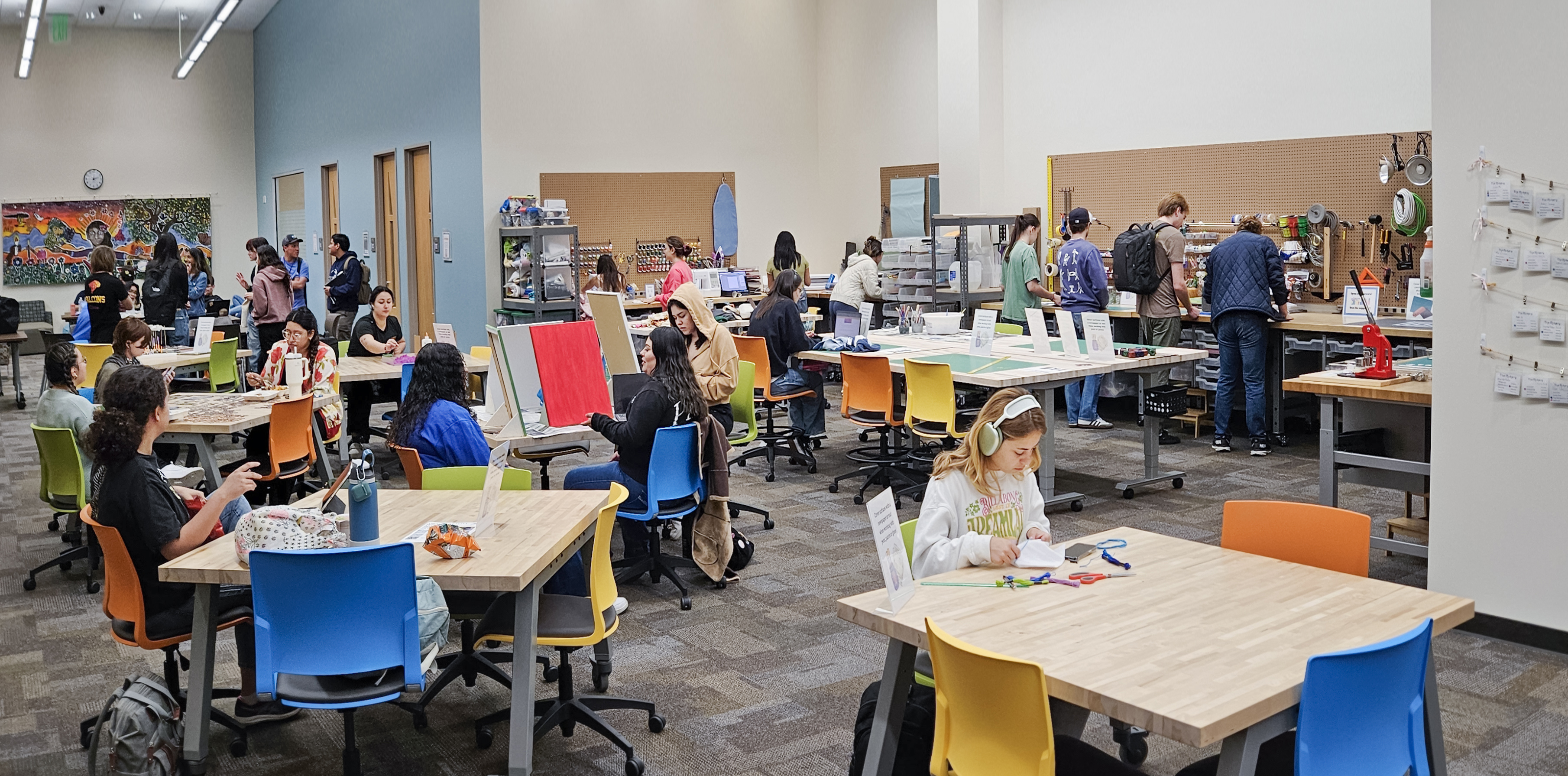 A large room with people sitting at tables.