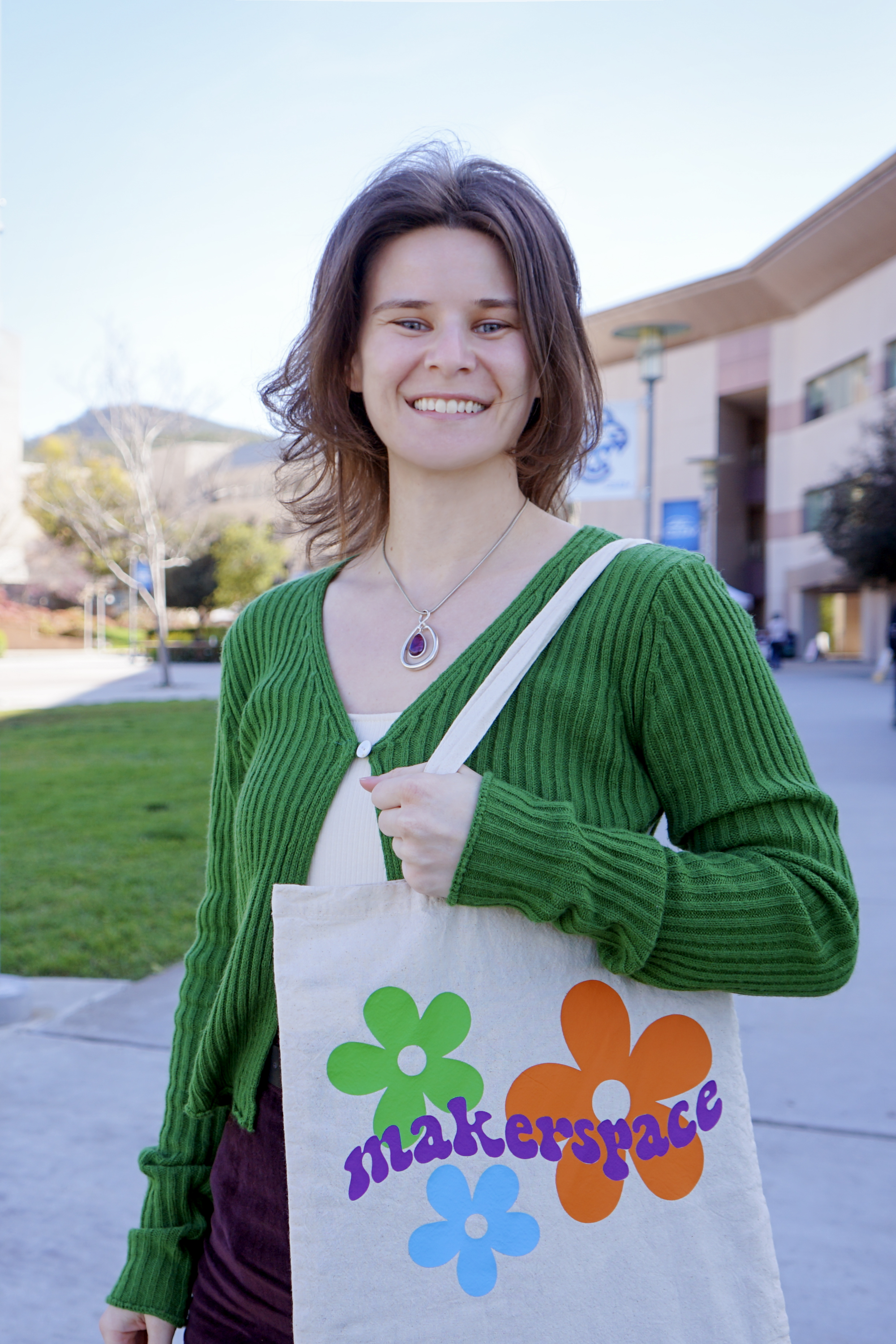 Woman smiling in front of a building.