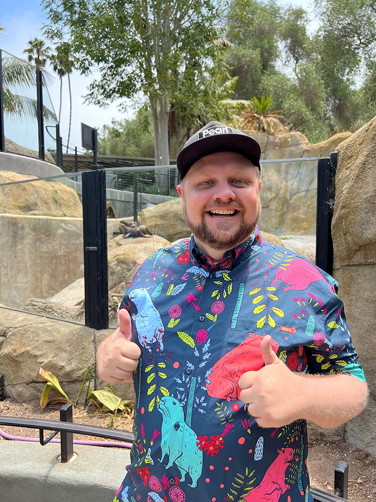 man with bright shirt and thmbs up