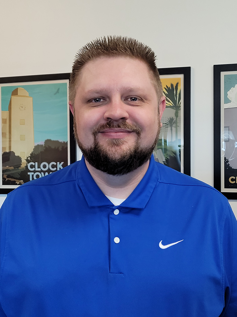 man in a blue shirt with short hair