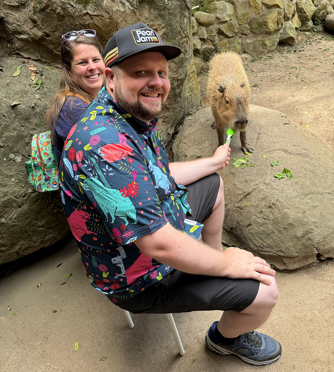 Man and woman with a capibara
