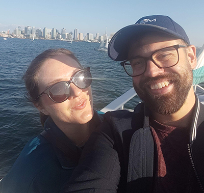 Two people on the water with a city's skyline in the background