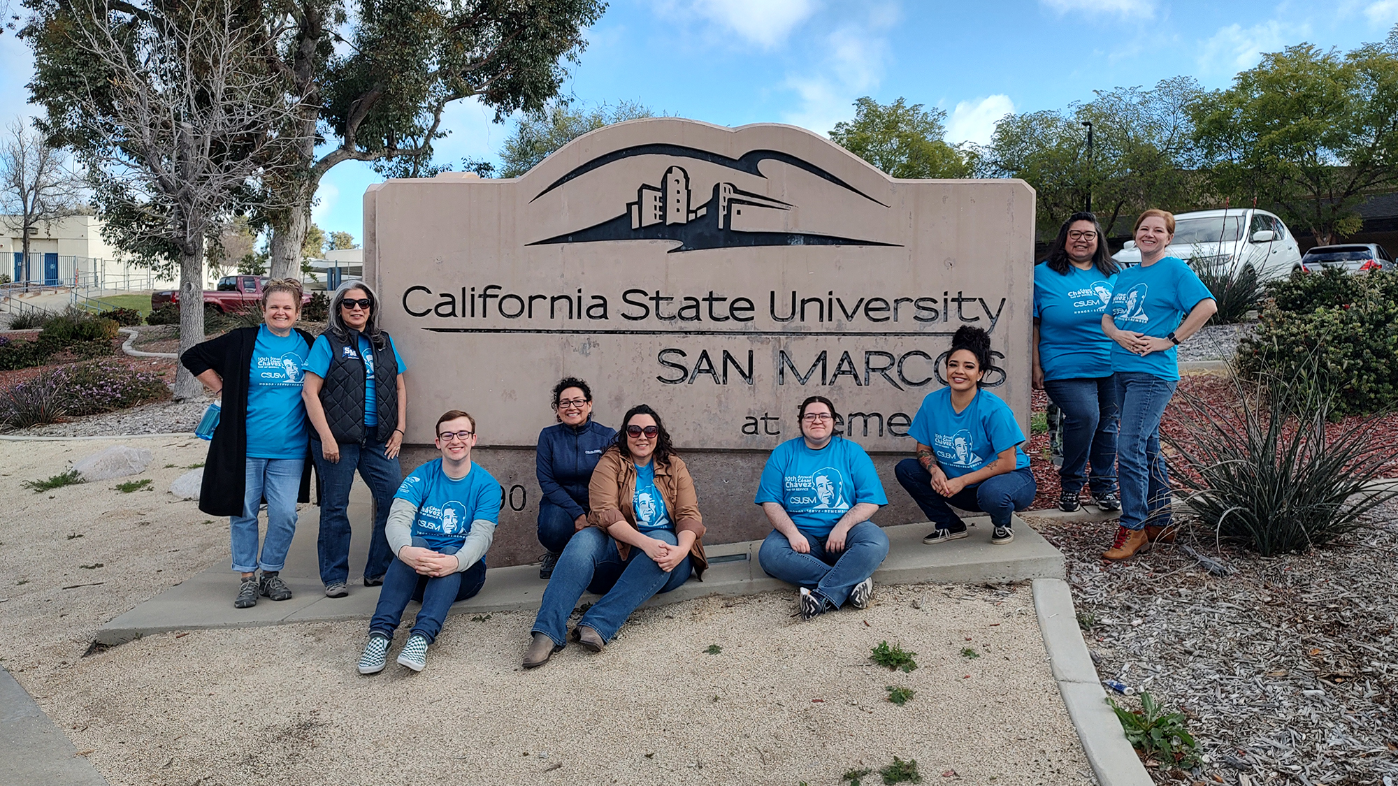 Group of people in front of a sign