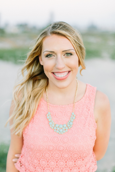 Megan in a pink sleeveless blouse