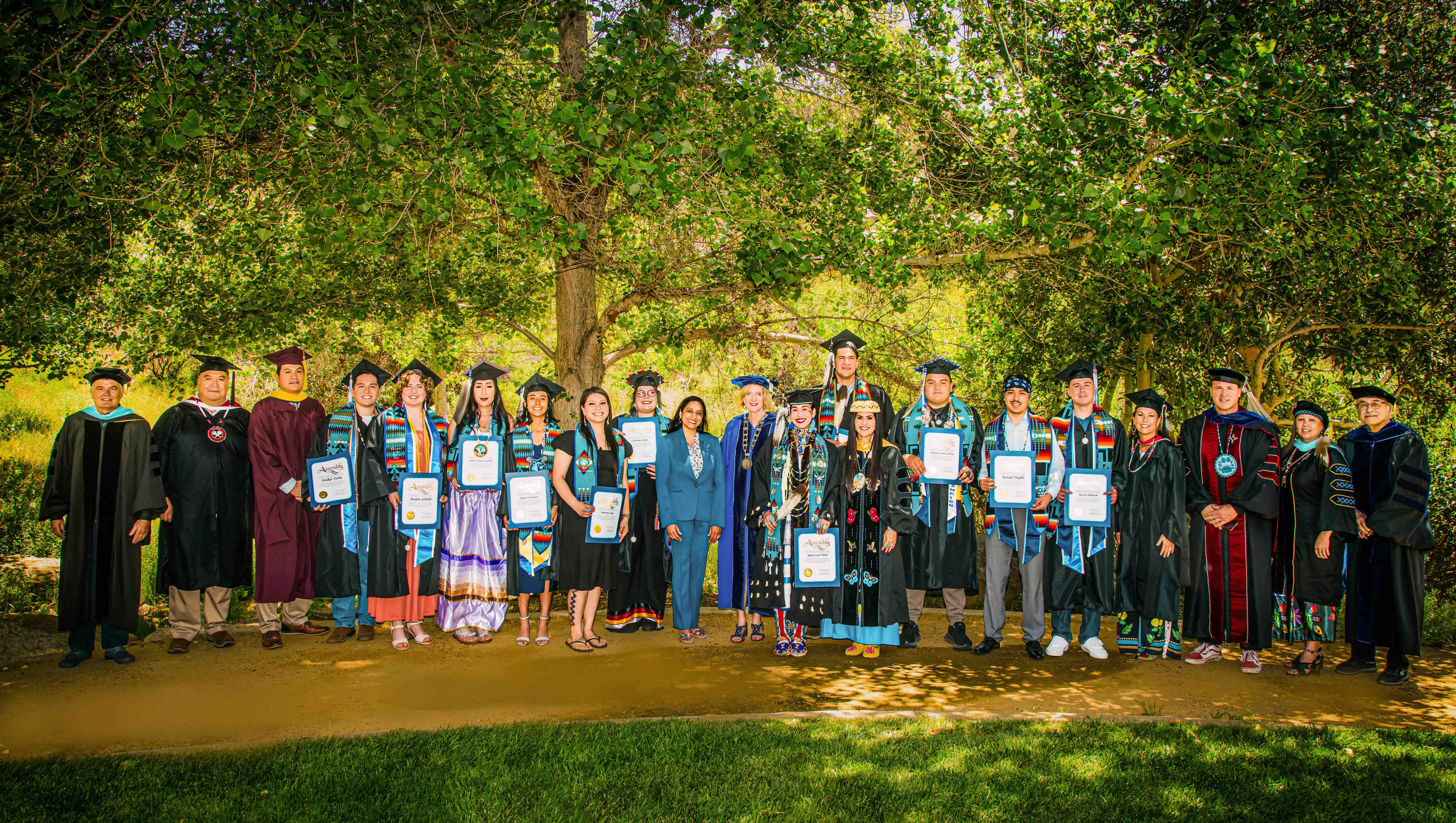 A group of people wearing regalia