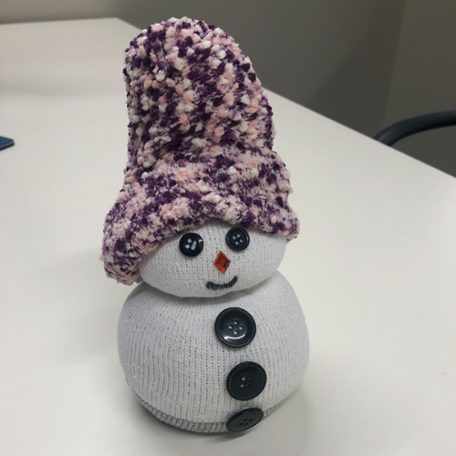 snowperson with purple and white hat