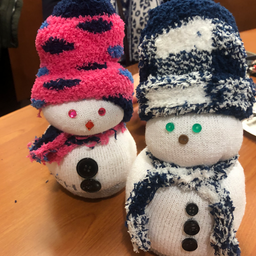 Two snowpeople, pink hat and blue hat