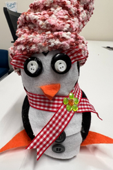 Crafted penguin with red sock hat