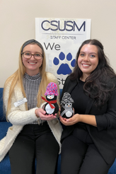 Two staff with their crafted penguins