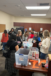 Large group of staff in the Staff Center selecting supplies