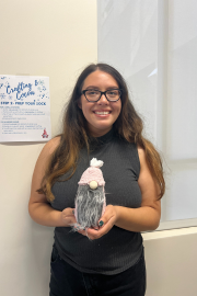 One woman posing with her crafted gnome