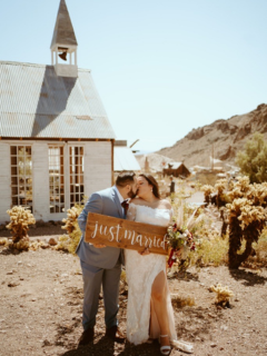 Edith and her husband kissing in front of chapel.