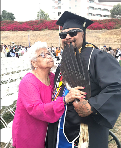 Martin with his mother during Commencement after giving him eagle wings.