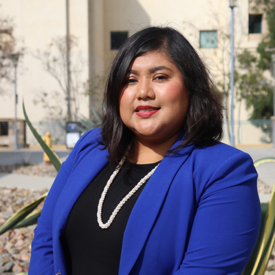 Woman with dark hair and a blue blazer