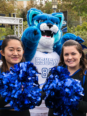 Crash the Cougar with students in Cougar Blue