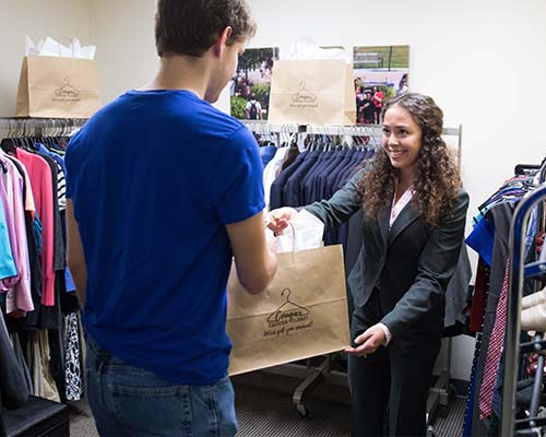 Student receiving clothes at Cougar Career Closet