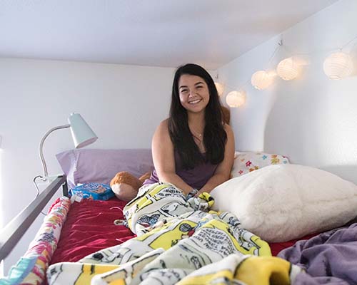 Student in decorated bedroom